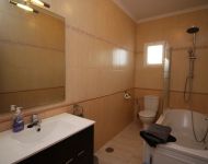 Spacious bathroom with spa bath.